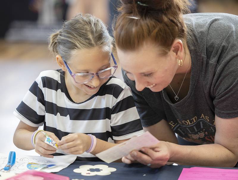 Claire Hurley, 8, and mom Kayla Layton of Sterling make crafts Wednesday, June 25, 2025, at the Odell Library in Morrison. The Whiteside County United Way and LIFE (Literacy of Fun for Everyone) sponsored Dolly's Book Bash at the library. The celebration honors Dolly Parton's Imagination Library and the transformative power of reading.