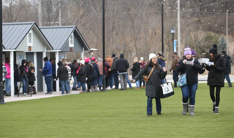 Wine enthusiasts stroll during the Winter Wine Walk on Saturday, Feb. 8, 2025 at the Market on Mill plaza in Utica.