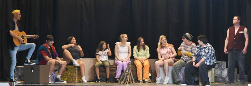 Cast members rehearse The Campfire Song at Camp Half-Blood.