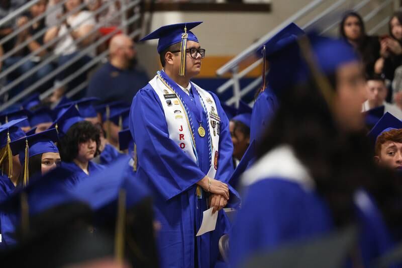 A graduate stands in recognition at the Joliet Central Class of 2023 Commencement Ceremony on Saturday, May 20, 2023, in Joliet.