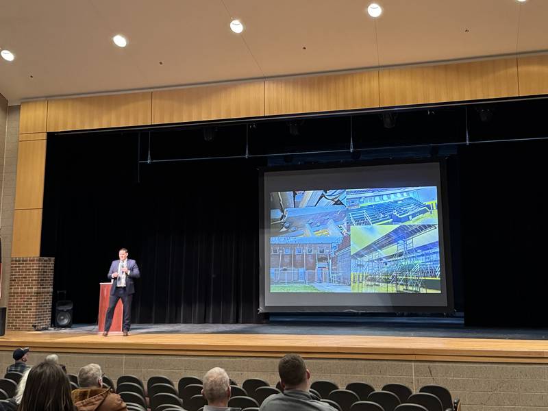 Coal City Unit 1 Superintendent Chris Spencer shows photos of the damage to Coal City Intermediate School during a town hall meeting Wednesday.