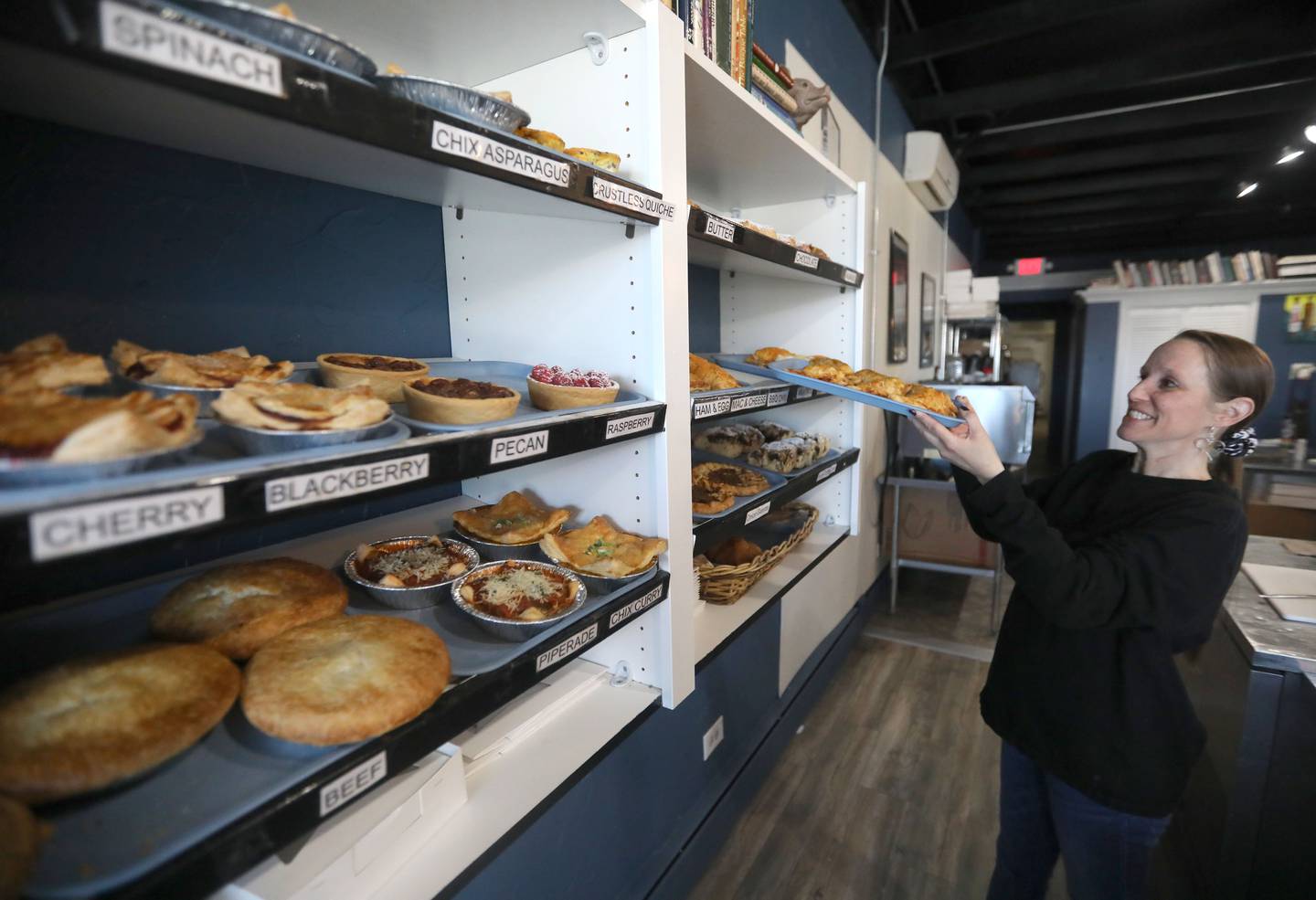 Katie Pippenger of Pots and Pies Bakery restocks the bakery shells on Thursday, March 12, 2026, as the bakery prepares for Pi Day on March 14, at the bakery in Crystal Lake.