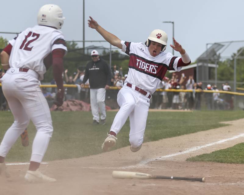Plainfield North's Matt McCormick (19) goes into his slide to the plate with the winning run for the Class 4A Plainfield North Regional final baseball game over Oswego. Saturday, May 31, 2025 in Plainfield.