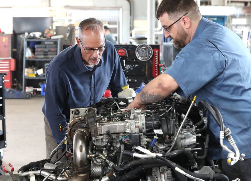 Jon Bockman, (left) owner of Bockman’s Auto, Truck & Tire, looks over a motor with lead technician Adam Zonka Friday, Aug. 2, 2024, at the DeKalb location on Industrial Drive.
