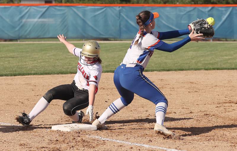 Genoa-Kingston's Olivia Vasak takes the throw as Stillman Valley's Ellie Larson slides into third  safely during their game Tuesday, April 18, 2023, at Genoa-Kingston High School.