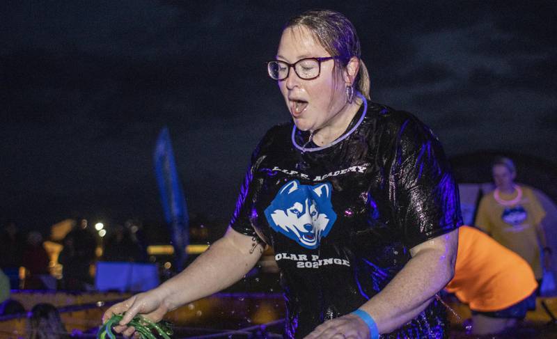 A woman emerges from water during a Special Olympics Illinois polar plunge fundraiser.