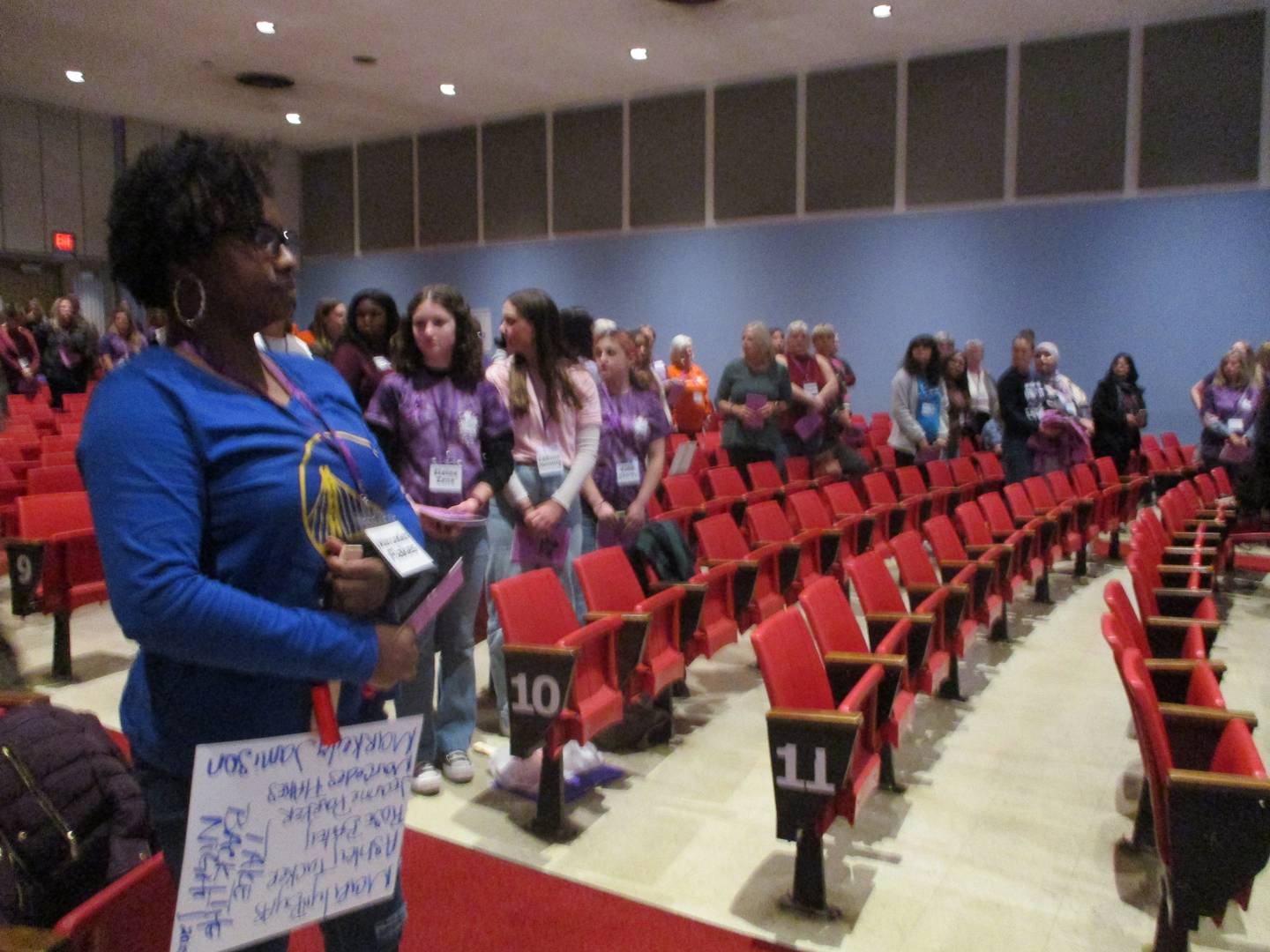 Tiffiney Byas of Joliet rises for the Pledge of Allegiance at the start of the Take Back the Night ceremony in the auditorium at Hufford Junior High School in Joliet on Thursday, Oct. 20, 2022.