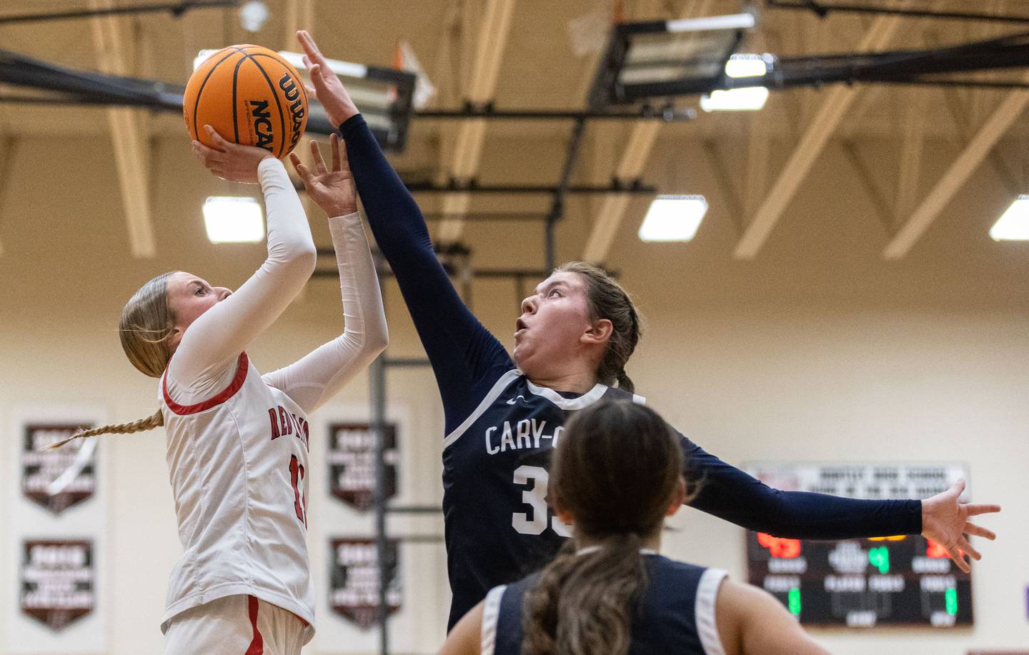 Cary-Grove High School forward Ellie Mjaanes, right, blocks Huntley High School guard Anna Campanelli’s shot during a game at Huntley High School on Tuesday, Dec. 3, 2024.
