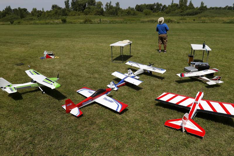 With a field full of radio-controlled planes behind him, Larry Erbach flies his plane on Thursday, Aug. 8, 2024, with other members of the Chain-O-Lakes Eagles R/C Club near Hebron.