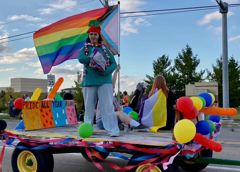 DeKalb's Pride club members dressed for the occasion as they toss candy to children watching the annual DeKalb High School Homecoming Parade on Wednesday, Sept. 24, 2025, along West Dresser Road.