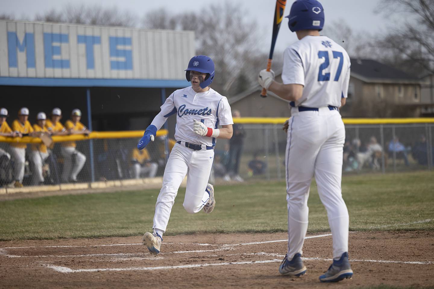 Newman’s Garret Matznick scores on a wild pitch against Sterling Tuesday, March 12, 2024.