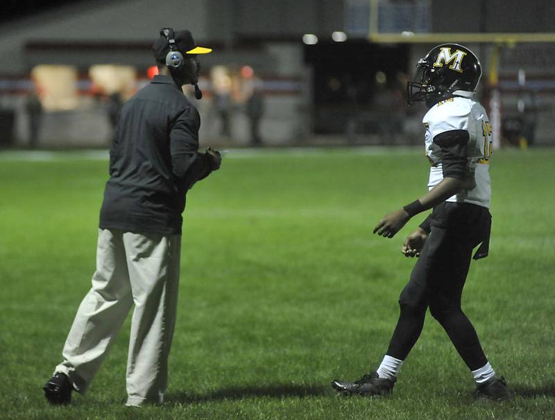 Marian Catholic Head Coach Erick Middleton  talks to his quarterback Ronald Thomas III as Marian Central takes on Marian Catholic during their week 3 football game at Marian Central High School on Friday, Sep. 13, 2019 in Woodstock.