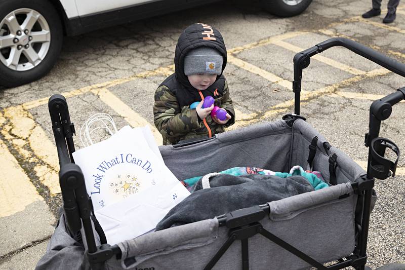 Benton Shepard, 2, of Rock Falls brings in an armload of plastic eggs on Saturday, April 1, 2023 at the Coloma Park District egg hunt.