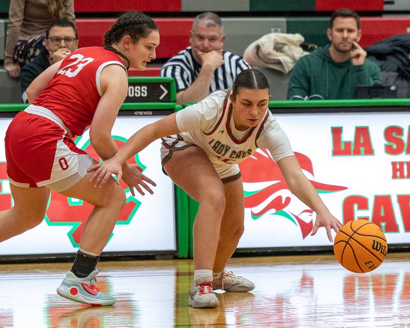 Kendal Bassett (12) of LaSalle-Peru loses dribble whilst Mary Stisser (23) of Ottawa trails on Wednesday, December 17, 2025 at Sellet Gymnasium in LaSalle.