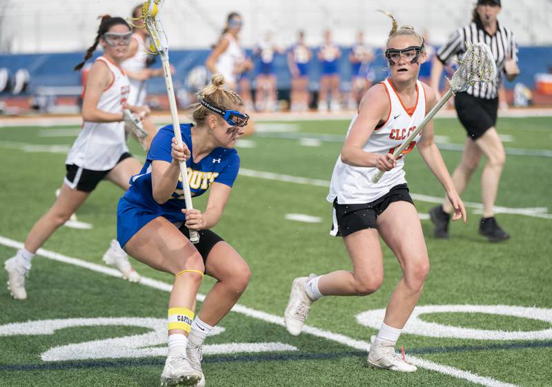 Lake Forest's Kate Kaptrosky looks to pass past Crystal Lake Central Co-Op's Piper Lefevre during the girls lacrosse supersectional match on Tuesday, May 31, 2022 at Hoffman Estates High School.