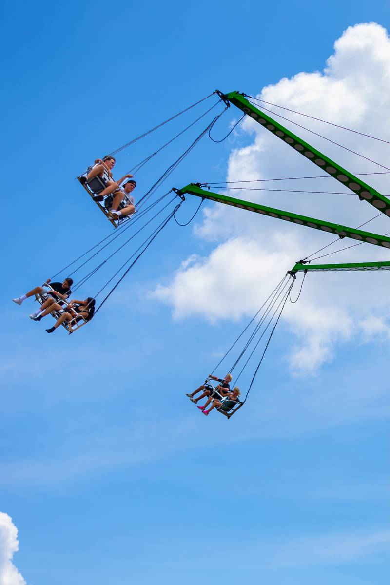 Plainfield Fest attendees ride the swings during the early afternoon on June 29, 2025.