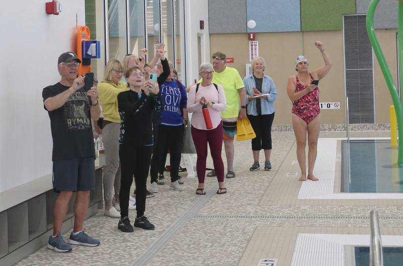 Supporters, staff and other volunteers cheer on Robert "Spider" Purcell in the O'Brien Aquatic Center on Monday, May 6, 2024 at the YMCA in Ottawa. Purcell was the first person to swim in the gigantic pool.