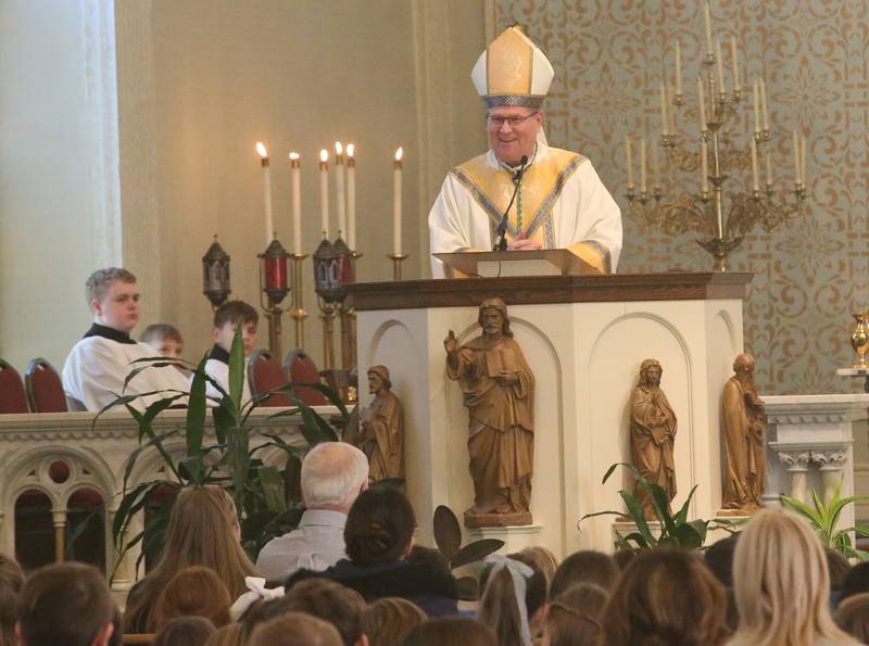 The Most Reverend Bishop Louis Tylka, Bishop of Peoria, delivers a homily to students from Trinity Catholic, Oglesby Holy Family and Peru Catholic Schools during a All Schools Mass on Thursday, Feb. 20, 2025 at St. Patrick's Catholic Church in La Salle. The bishop announced a new name for the three schools calling it Carlo Acutis. Last year, the Catholic Diocese of Peoria announced the consolidation of the three schools. Carlo Acutis Canonization will take place on Sunday, April 27, 2025 during the Jubilee of Teenagers in Rome. Acutis is the first millennial saint, representing those born between the early 1980's and the late 1990's. He is celebrated for cataloging miracles and online and managing websites for Catholic organizations.