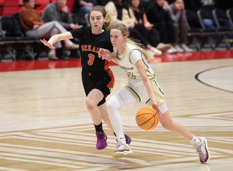 Sycamore's Sadie Lang drives by DeKalb's Olivia Schermerhorn during their game Friday, Jan. 31, 2025, in the FNBO Challenge in the Convocation Center at Northern Illinois University in DeKalb.