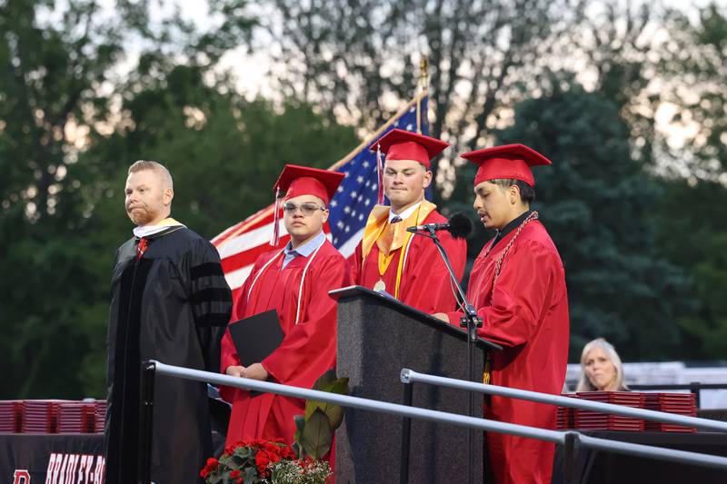 Student speaker Jostin Ramirez, right, shares his story during the Bradley-Bourbonnais Community High School commencement ceremony on Thursday, May 21, 2026. Fellow student speakers Calvin Kohl, secoond from right, and Derek Otero listen next to Principal Evan Tingley, left.