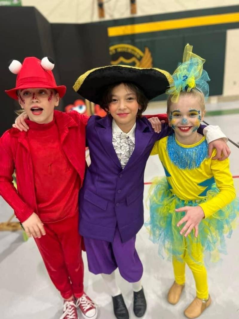 St. Michael the Archangel Catholic School students Brinley Stevens as Sebastian, Erin Seo as Grimsby and Scarlett Harcharik as Flounder pose during a recent performance of "The Little Mermaid."