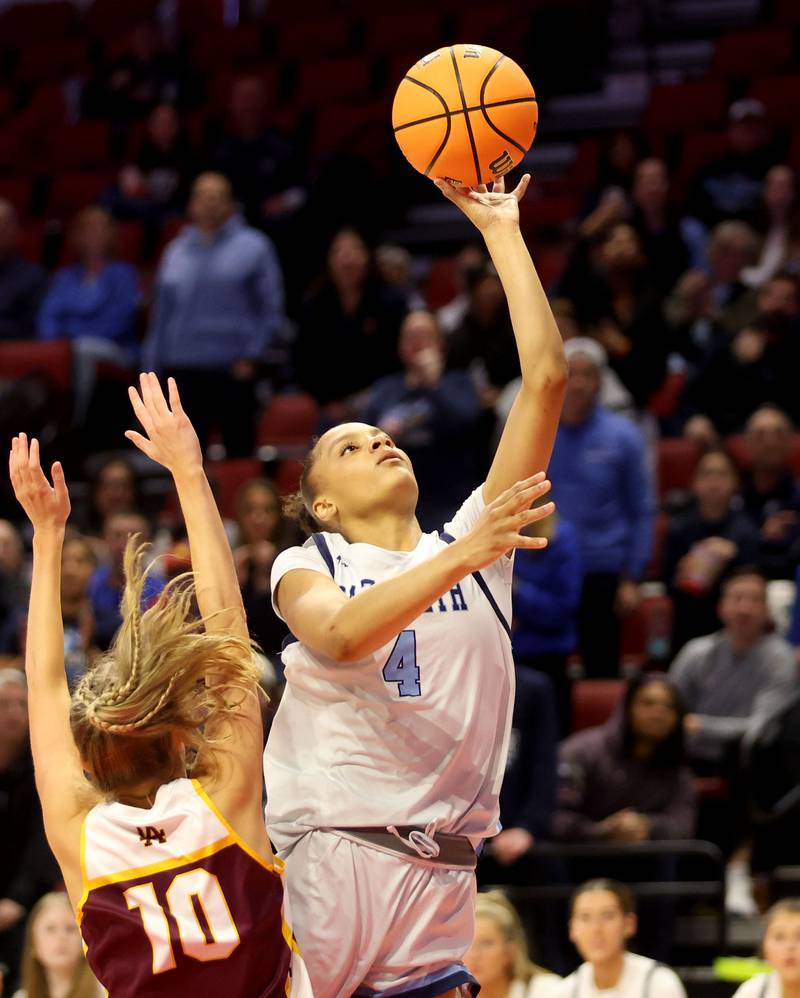 Nazareth's Mia Gage scores on a layup over Loyola's Clare Weasler during the Class 4A State girls basketball championship game on Saturday, March 7, 2026 at CEFCU Arena in Normal.