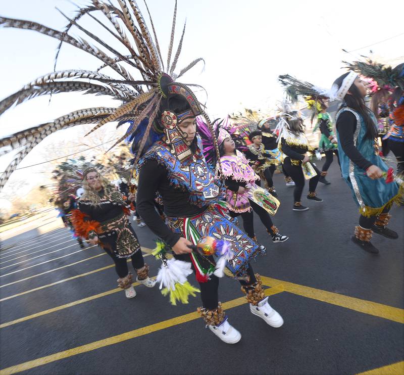 Danza Chichimeca, a troupe of dancers with St. Mary’s Parish in Bloomington, lead a procession from St. Michael the Archangel Church, Streator, following Mass on Sunday, Dec. 8, 2024. The troupe was brought in to celebrate the Feast of Our Lady of Guadalupe, which commemorates Marian apparitions that ushered in the mass conversion of indigenous peoples to Christianity in the 16th century.
