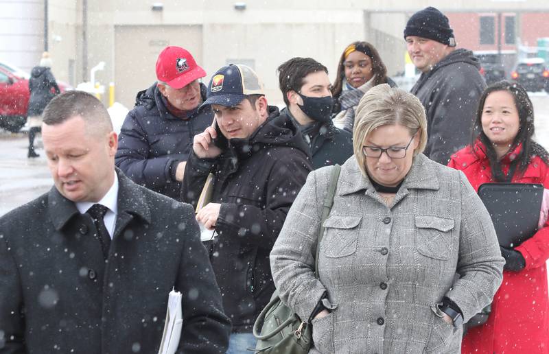 Candidates wait in line on a snowy Monday, March 7, 2022, at the DeKalb County Administration Building in Sycamore, to file their petitions to get their names on the ballot for the November 2022 midterm election. Monday was the first day candidates could file.