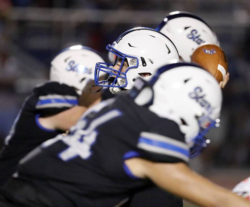 St. Charles North's Ethan Plumb (10) looks for an open teammate Friday August 25, 2023 in St. Charles.