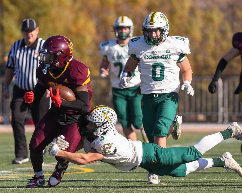 Montini Catholic's Isaac Alexander (28) runs the ball for some yards before being brought down by Coal City's Brody Widlowski (3) during the 4A quarterfinals game on Saturday Nov. 15, 2025, held at Montini Catholic High School.