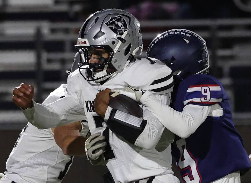 Kaneland's Jalen Carter secures the football as Belvidere North's Nolan Vaughn tries to strip it Friday, Nov. 7, 2025, during their Class 5A second round playoff game at Belvidere North High School.