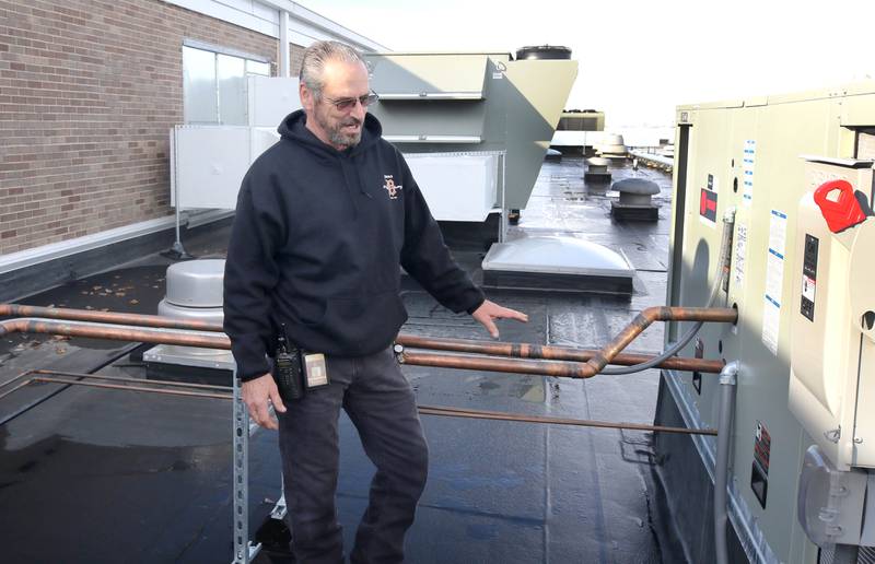James Orr, with DeKalb School District 428 maintenance, talks Thursday, Nov. 3, 2022, about the piping for the new air conditioning units on the roof of Huntley Middle School.