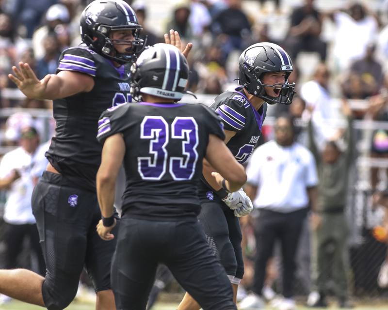 Downers Grove North's Connor Crowley (21) celebrates a defensive stop during football game between Downers Grove North at Morgan Park Saturday, Aug 30, 2025  in Chicago.
