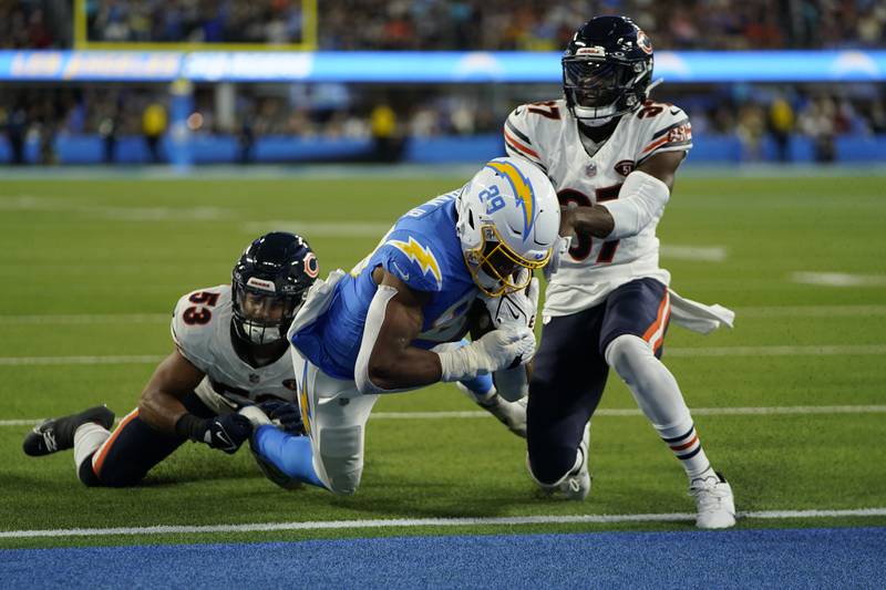 Los Angeles Chargers tight end Donald Parham Jr., center, scores a touchdown as Chicago Bears linebacker T.J. Edwards, left, and safety Duron Harmon defend during the first half Sunday, Oct. 29, 2023, in Inglewood, Calif.