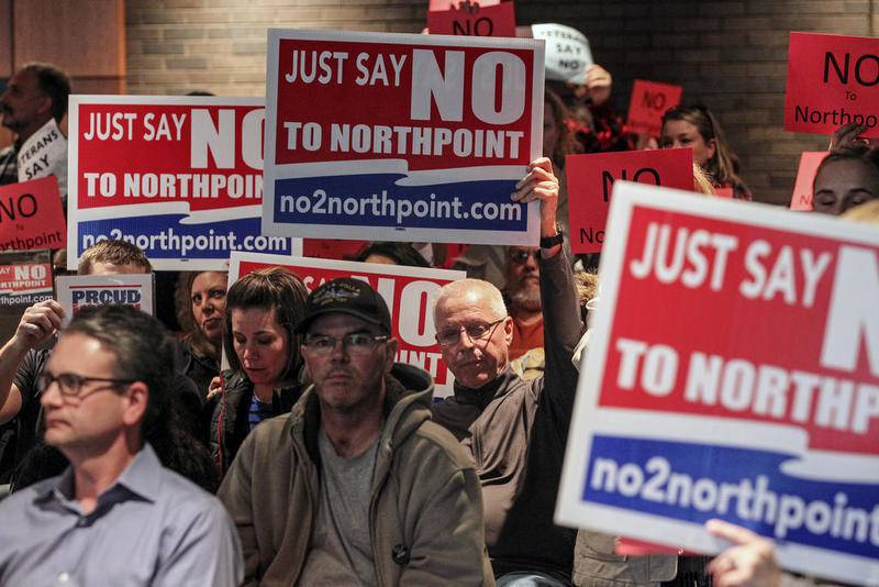 Opponents show their disagreement with the NorthPoint Development project at a Feb. 24 meeting of the Joliet Plan Commission.