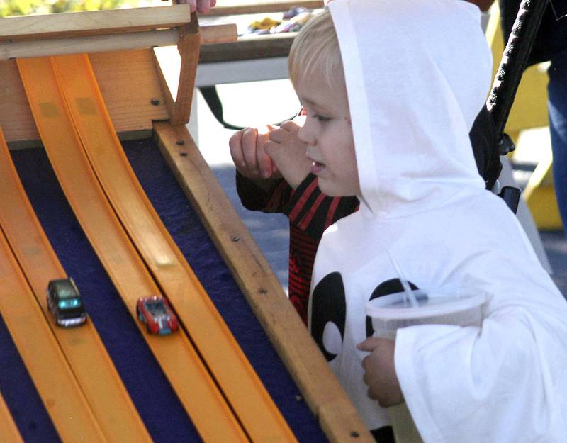 Ollie Ptasnik of Polo watches his Hot Wheels car at the start. The Craft Beer Festival and Halloween Town offered fun for all in downtown Sterling on Saturday, Oct. 11.