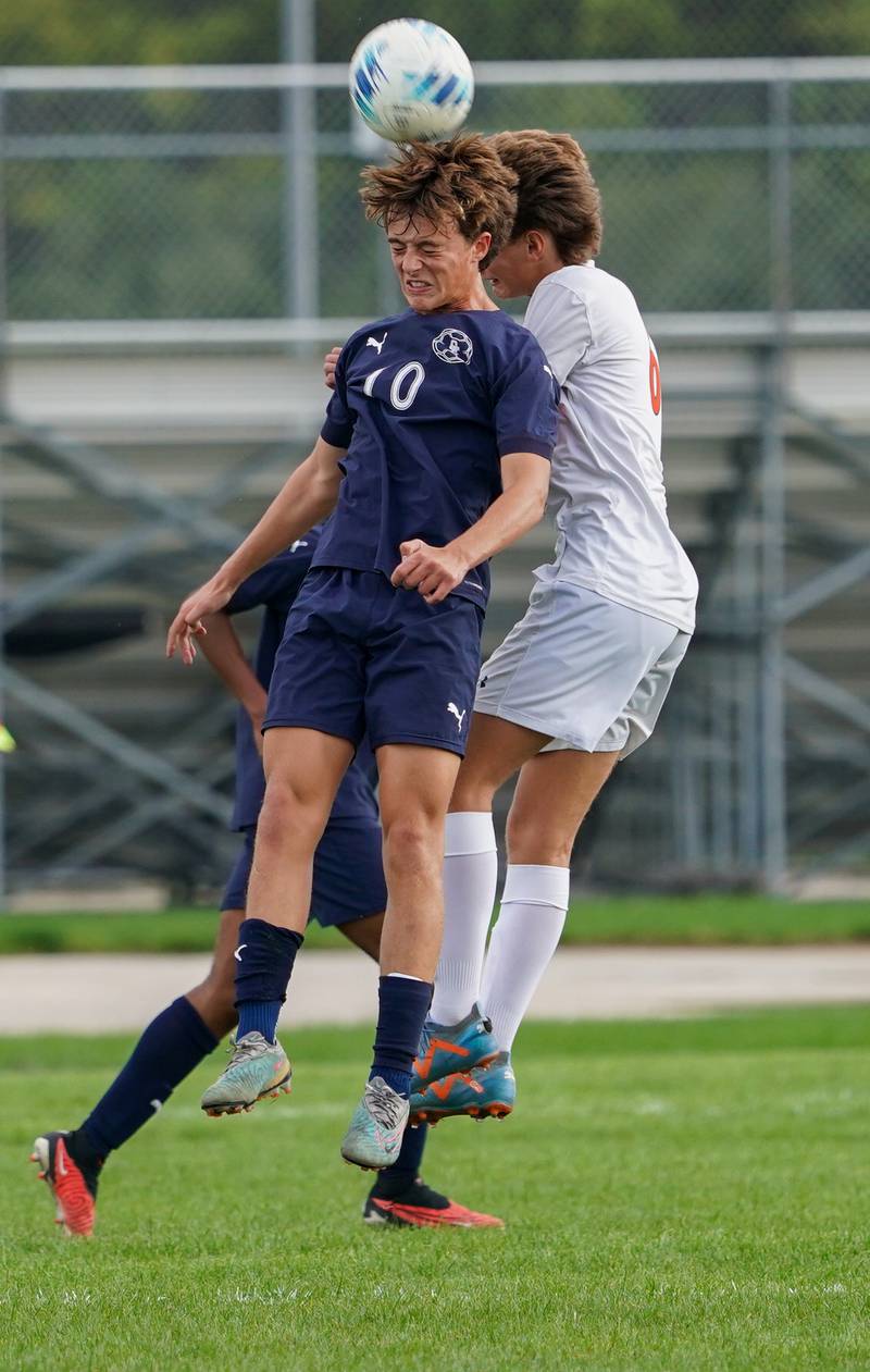 Oswego East's Dylan Drendel (10) goes up for a header against Oswego during a soccer match at Oswego East High School on Tuesday, Sept. 26, 2023.