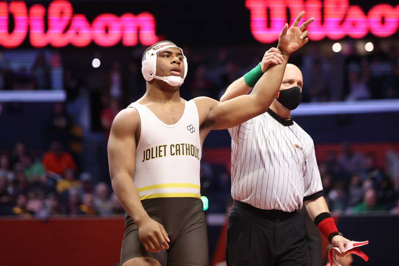 Joliet Catholic’s Dillan Johnson set a state record with a record fall in :30 seconds against Fenwick’s Jimmy Liston in the Class 2A 285lb. championship match at State Farm Center in Champaign. Saturday, Feb. 19, 2022, in Champaign.