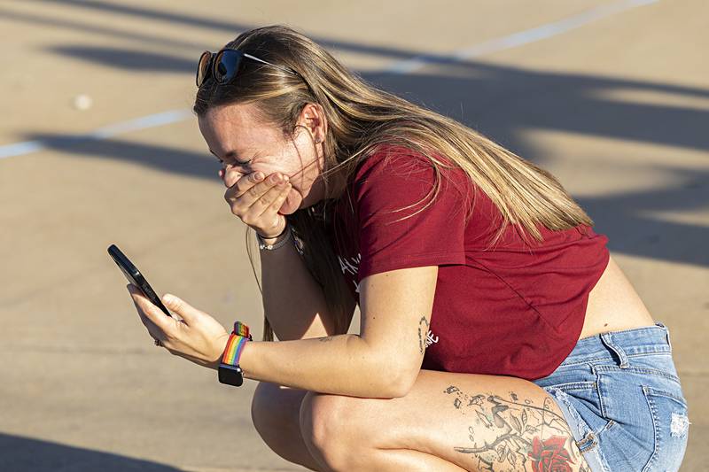 Samantha Johnson of Dixon doubles over in laughter at a picture she took of Aubree Johnson Saturday, Aug. 10, 2024, at Dixon’s Venetian Night. Samantha was laughing after a street performer startled Aubree during the photo shoot.