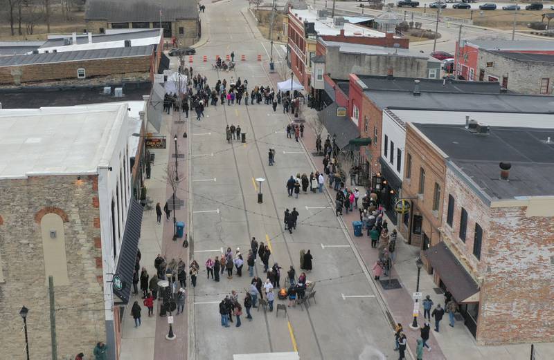 People gather on Mill Street for the annual Winter Wine Walk on Saturday, Feb. 8, 2025 in Utica.