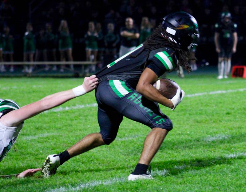 Rock Falls running back Booker Cross tries to break free from a North Boone defender who is grasping his jersey on Friday, Oct. 8, 2021.