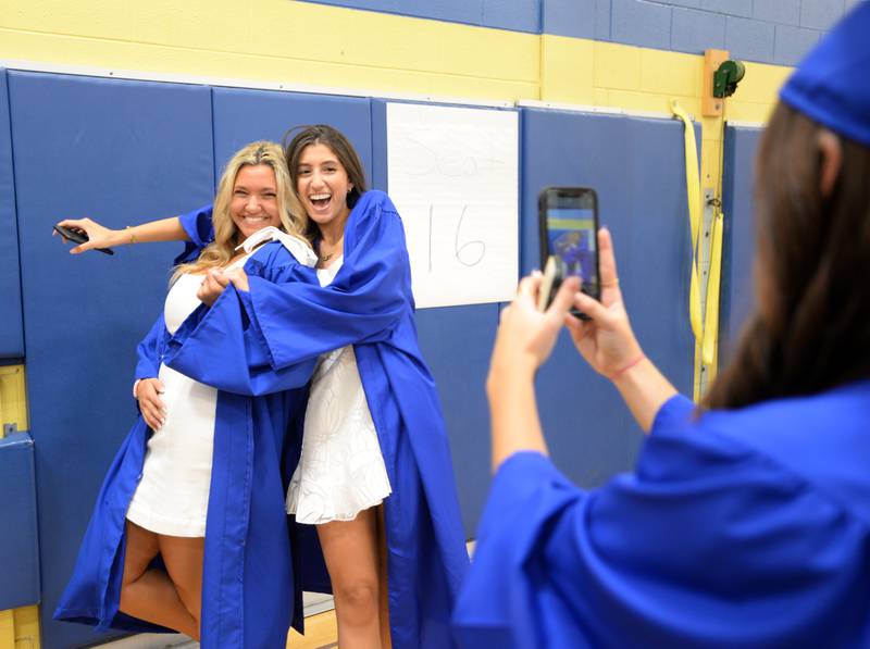 Mikayla McGovern of Indian Head Park takes a picture of (left) Kristin Orrick  and Ruba Mostafa of Willow Springs at Lyons Townships graduation held Wednesday May 25, 2022.