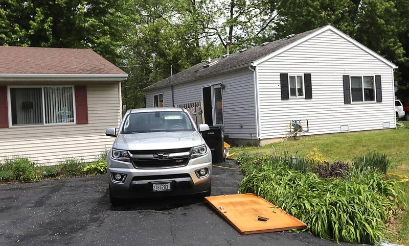 The front door of the home that exploded lays the drive was of a home a two houses away on Monday, May 18, 2026, in 7400 block of Birch Drive, in Wonder Lake, after the Sunday evening explosion. One resident of a home was killed and two others have been taken to the hospital.