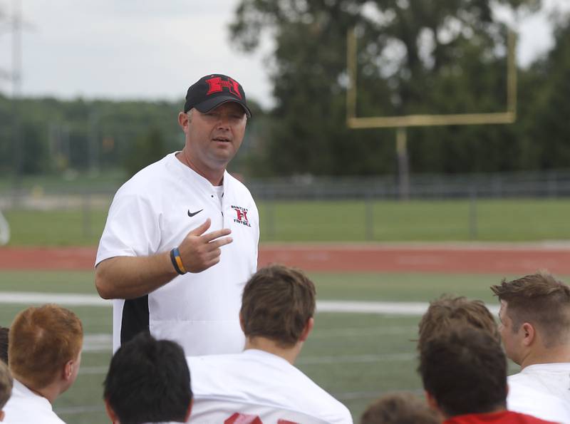 Huntley football Mike Naymola speaks to the team during the first day of football practice Monday, August 7, 2023, at the Huntley High School’s Red Raider Stadium.