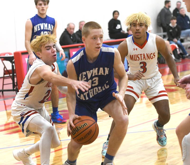Newman's George Jungerman drives the baseline as Morrison's Danny Mouw and DeShaun McQueen defend during afternoon action at the Oregon Thanksgiving Tournament on Saturday, Nov. 26.