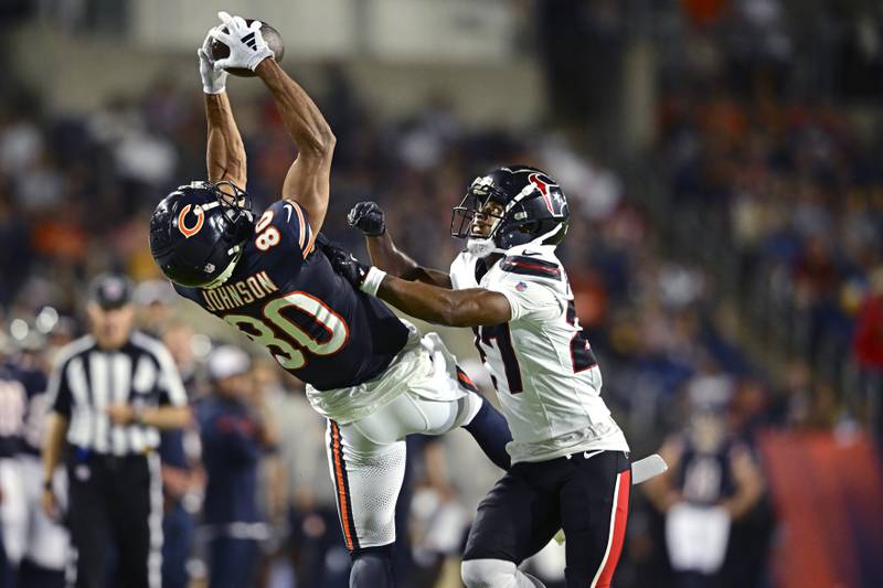Chicago Bears wide receiver Collin Johnson (80) catches a pass for a first down with Houston Texans cornerback Troy Pride Jr. (27) defending during the second half of an NFL exhibition Hall of Fame football game, Thursday, Aug. 1, 2024, in Canton, Ohio. (AP Photo/David Dermer)