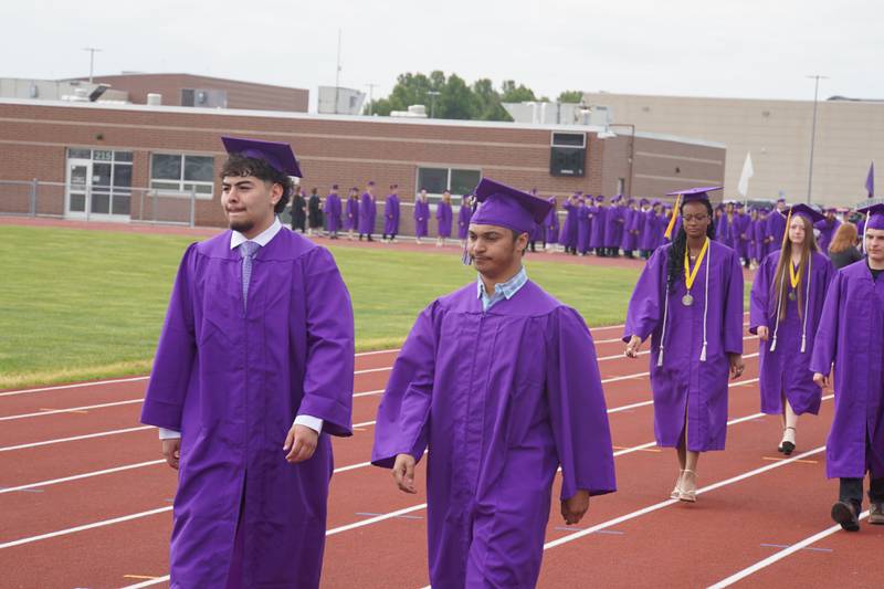 Rochelle Township High School graduating seniors walk to the football field on Saturday, May 23, 2026.