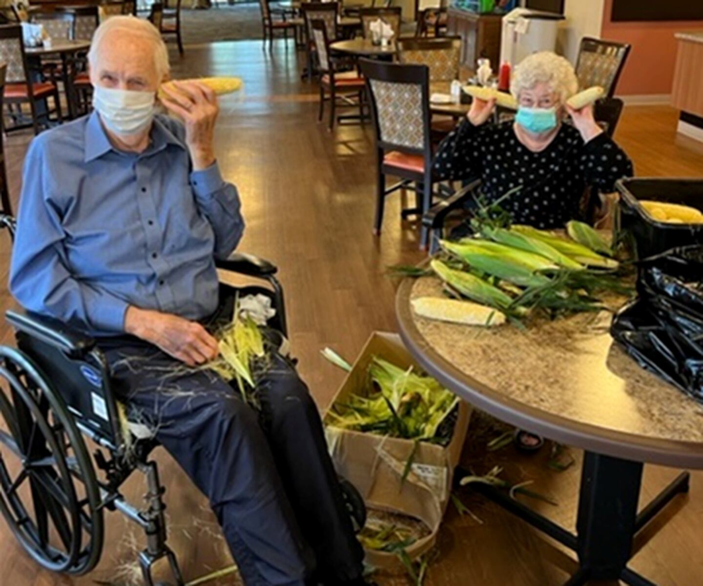 Resthave Care and Rehabilitation residents Don VanDerLeest and Tess Zilly shucking a batch of corn donated to the facility. Resthave residents and staff shuck the corn, which is then cut off of its ears and frozen into bags to be enjoyed by the residents at a later date.