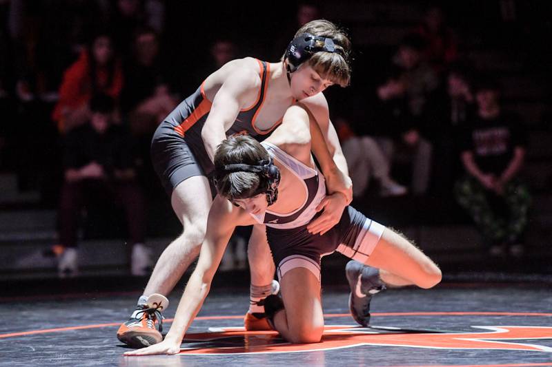 St. Charles East's Dom Munaretto and Marian Central's Chandler Gardner wrestle at 113 pounds during a match in St. Charles on Wednesday, December 20, 2023.