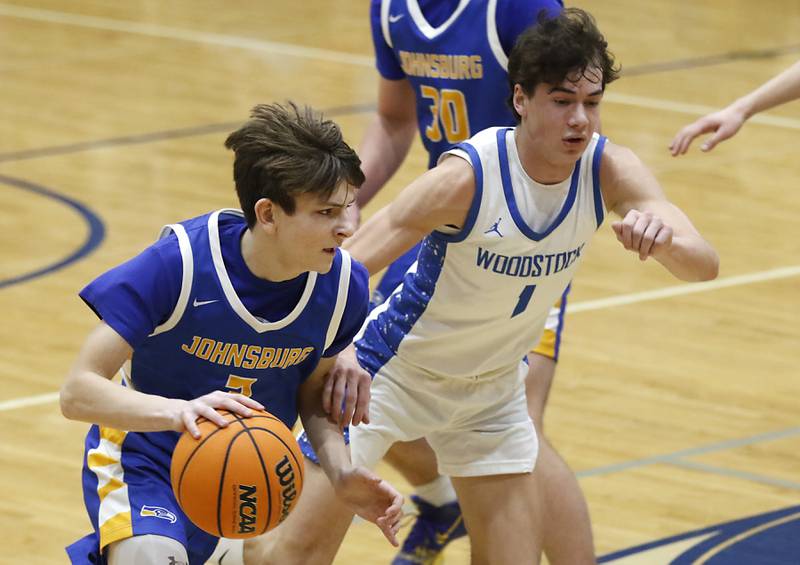 Johnsburg's Trey Toussaint drives to the basket against Woodstock's Collin Greenlee during a Kishwaukee River Conference basketball game on Friday,  Feb. 14, 2025, at Woodstock High School.
